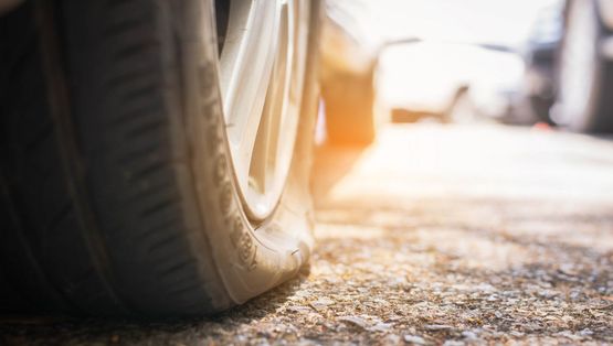 Close-up view of a tire resting on the ground tyre need to replace..